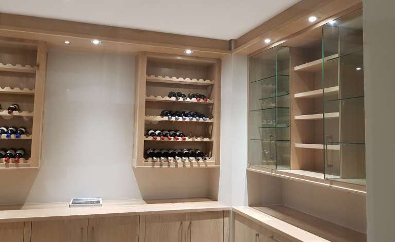 Solid Oak and Oak veneer wine cellar with glass display and cigar storage and display section. Including two wine shelving units with horizontal bottle display.